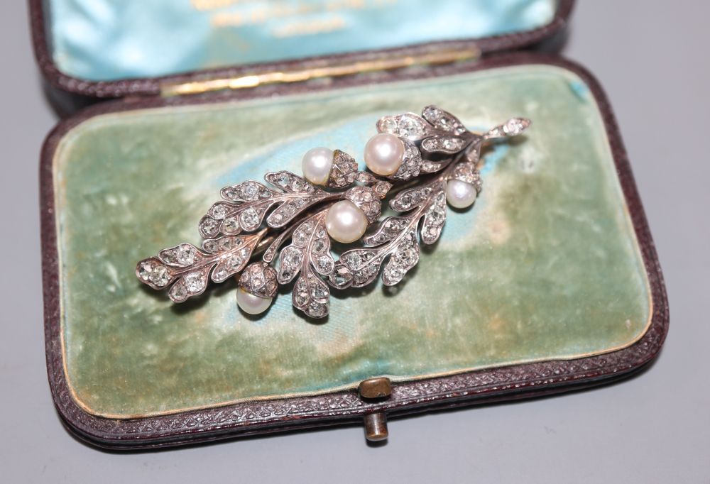 An early 20th century yellow and white metal, cultured pearl, rose and round cut set floral spray brooch, 55mm, gross 10.9 grams.